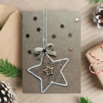 Handmade Rustic Christmas card with burlap and wooden stars on brown paper. White jute stars tied with white ribbon.
