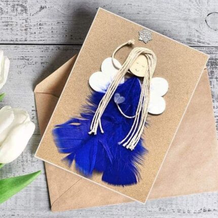 Charming Handmade Card for Women made of dark blue feathers and wooden wings on brown paper.