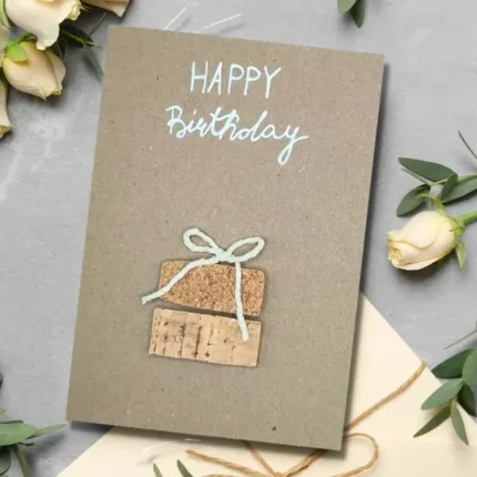 Charming Homemade Birthday Card – Celebrate with a Truly Unique Design. Made of cork and white cotton bow on brown paper.