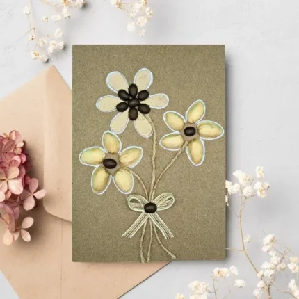 Handmade thank you card for mum or dad with yarn and fabric details depicting a girl jumping rope, set against a brown cardstock background. Includes a red paper heart and a kraft paper envelope.